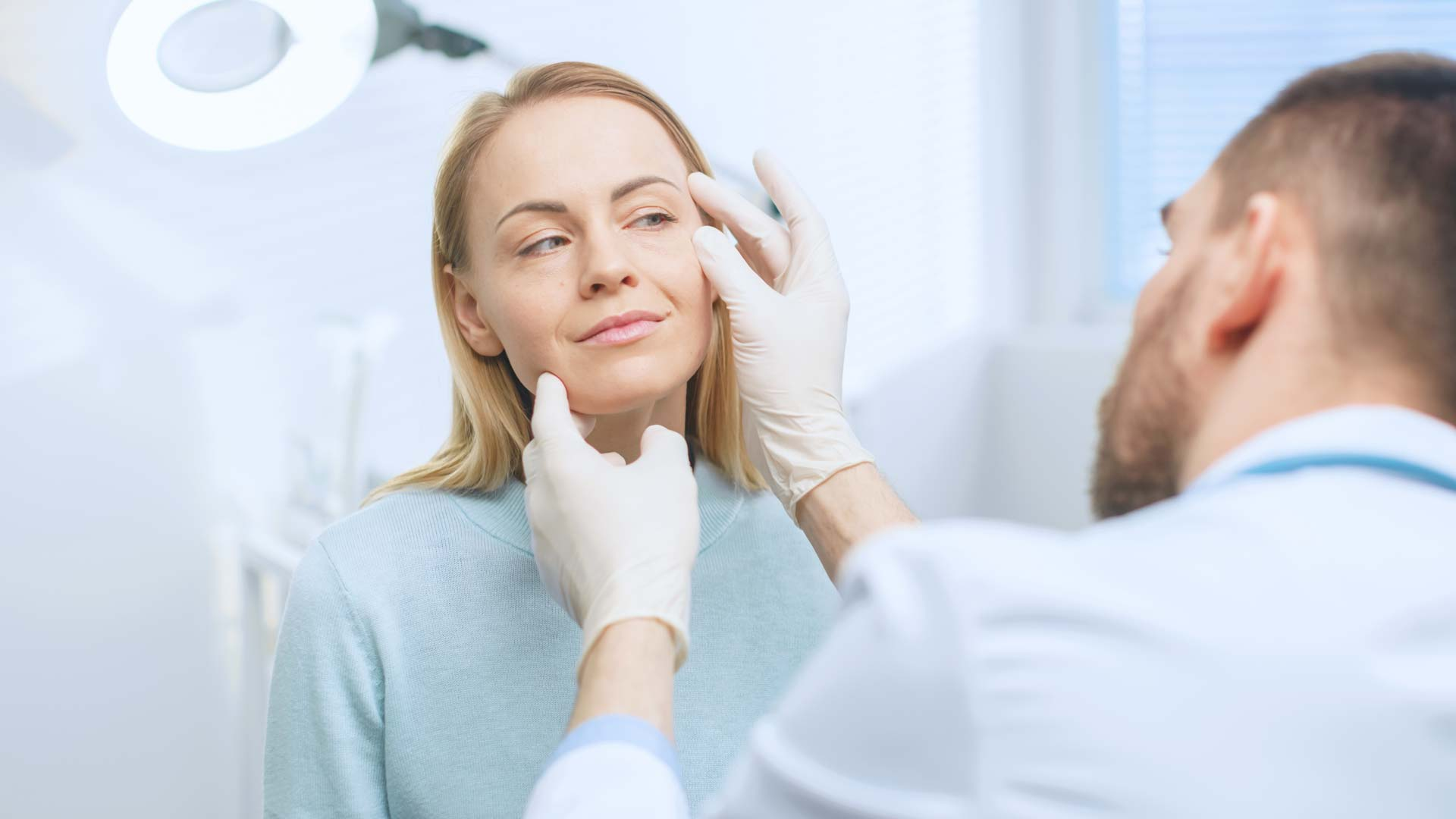Consultant assessing a patient before cosmetic surgery at LHCSC London